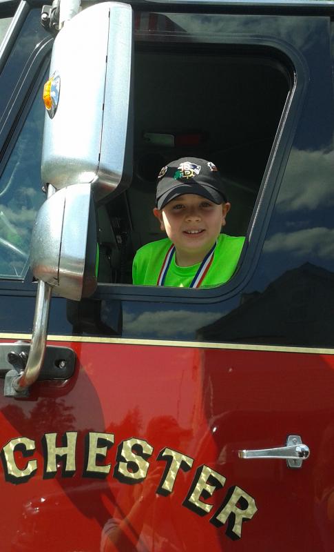 Ryan Hammond checks out the view from the driver’s seat of a Rochester fire engine. COURTESY LISA FULLER